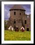 Traditionally Dressed Girls Walk Through Dandelions, Cesis Castle, Latvia by Janis Miglavs Limited Edition Print
