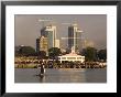 Fishing Dhow In Front Of Fish Market With Skyscrapers Behind, Dar Es Salaam, Tanzania by Ariadne Van Zandbergen Limited Edition Print