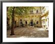 Table And Chairs In The Courtyard Of A Yellow Building by Jason Edwards Limited Edition Pricing Art Print