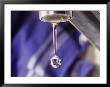 A Close-Up Of A Faucet With A Single Drop Of Water Coming Out Of It by Todd Gipstein Limited Edition Print