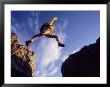 Backpacker Jumping To Rocks, Park City, Ut by Cheyenne Rouse Limited Edition Print