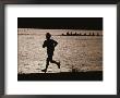 Silhouette Of A Jogger Next To Water by Roy Gumpel Limited Edition Print