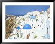 Oia With Blue Domed Churches And Whitewashed Buildings, Santorini (Thira), Cyclades Islands, Greece by Lee Frost Limited Edition Print