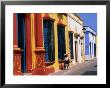 Woman Walking Past Colourful House Facades On Street, Campeche, Mexico by John Elk Iii Limited Edition Print