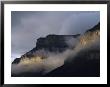 A Mountain Peaks Through The Clouds In Banff National Park by Stephen Alvarez Limited Edition Print