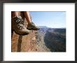 The Boot-Shod Feet Of A Hiker Dangle Over The Side Of A Cliff by John Burcham Limited Edition Pricing Art Print