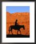 Cowboy On Mule Silhouetted Against Sandstone Cliff, Moab, Utah, Usa by Curtis Martin Limited Edition Print