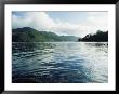 A Boat Plies The Gentle Waters Around Queen Charlotte Island by Bill Curtsinger Limited Edition Print