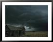 Heavy Dark Clouds Foretell A Possible Tornado Near An Old Homestead by Peter Carsten Limited Edition Print