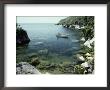 A Small Motorboat In A Lake Malawi Cove by Bill Curtsinger Limited Edition Print
