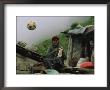 A Soccer Ball Flies Over The Head Of Woman Who Is Knitting Outdoors by Randy Olson Limited Edition Print