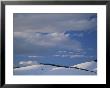 Big Clouds Fill The Sky Over A Hilly Winter Landscape by Michael Melford Limited Edition Print