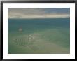 Shrimp Boat Hovers Above Rippled Sand In Wattenmeer National Park by Norbert Rosing Limited Edition Print