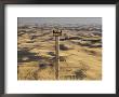 A Sign Looks Out Over Rolling, Dune-Like Wheatfields Extending To The Horizon by Robert Madden Limited Edition Print