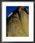 A Rock Climber Climbs A Rock Face Without The Aid Of Hooks Or Ropes In Needles, California by Barry Tessman Limited Edition Pricing Art Print