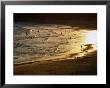 The Setting Sun Illuminates Surfers And Swimmers On Bondi Beach, Sydney, Australia by Glenn Beanland Limited Edition Print