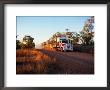Roadtrain Hurtles Through Outback, Cape York Peninsula, Queensland, Australia by Oliver Strewe Limited Edition Print