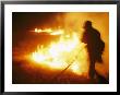 Fire-Fighter Silhouetted Against The Flames Of A Grass Fire by Mark Thiessen Limited Edition Pricing Art Print
