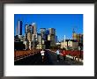 Women Jogging Across Stone Arch Bridge With City Skyline Beyond, Minneapolis, Usa by Richard Cummins Limited Edition Print