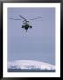 An Argentine Helicopter Flies Over Anvers Island by Gordon Wiltsie Limited Edition Print