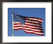 American Flag Blowing Against A Blue Sky On The Grounds Of The Washington Monument by Stephen St. John Limited Edition Pricing Art Print