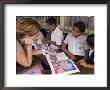 German Volunteer Helping Children With School Work, El Pochote, Near Granada, Granada, Nicaragua by Margie Politzer Limited Edition Print