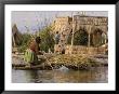 Woman With Boat Full Of Totora Reeds On Floating Islands, Islas De Los Uros, Lake Titicaca, Peru by Dennis Kirkland Limited Edition Print
