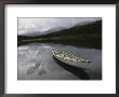 A Canoe Sits Tethered To Shore On A Beautiful Mountain Lake by Raymond Gehman Limited Edition Print