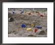 A Childs Colorful Toys Are Scattered Throughout A Sand Box by Roy Gumpel Limited Edition Print