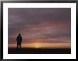 A Man Silhouetted Against The Evening Sky In The Yukon Territory by Michael Melford Limited Edition Pricing Art Print