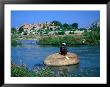 Fisherman On Rock In Tungabhadra River, Hampi, India by Peter Ptschelinzew Limited Edition Print