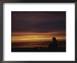Woman Sitting By Campfire On The Beach At Sunset by Todd Gipstein Limited Edition Print