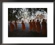 Buddhist Monks In Orange Robes Stand Outside An Ornate Building by Jodi Cobb Limited Edition Print