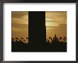 A Twilight View Of American Flags Flying At The Washington Monument by Karen Kasmauski Limited Edition Print