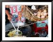 Basket Of Eggs Hanging In Front Of Woman Cooking Asian Stir-Fry, Rapid Creek Market, Australia by Will Salter Limited Edition Print