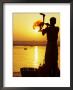 Priest Moves Lantern In Front Of Sun During Morning Puja On Ganga Ma, Varanasi, India by Anthony Plummer Limited Edition Print