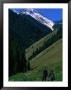 Trekkers Walk Between The Kol-Say Lakes With The Alatau Mountains Behind, Kazakhstan by Anthony Plummer Limited Edition Print