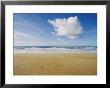 A Large Cloud Dominates The Sky As The Surf Rolls Onto A Sandy Beach by Skip Brown Limited Edition Print