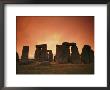 The Setting Sun Casts An Eerie Glow Over Stonehenge by Richard Nowitz Limited Edition Print