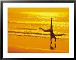 Girl Doing Cartwheels On Beach At Sunset by Jennifer Broadus Limited Edition Print
