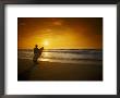 Surfer Holding Surfboard On Beach At Sunset by Doug Mazell Limited Edition Print