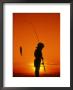 Silhouette Of Boy Fishing At Sunset by Dean Berry Limited Edition Pricing Art Print