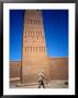 Man Walking Past Minaret, Part Of Oulad Driss Kasbah, Near M'hamid, M'hamid, Morocco by Damien Simonis Limited Edition Print