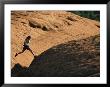 A Woman Hikes On Red Rocks In Northern Arizona by Dugald Bremner Limited Edition Pricing Art Print