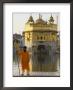 Shrine Guard In Orange Clothes Holding Lance Standing By Pool In Front Of The Golden Temple by Eitan Simanor Limited Edition Pricing Art Print