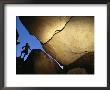 A Silhouetted Climber Surveys Indian Pictographs Inscribed Upon A Rock by Bill Hatcher Limited Edition Print