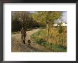 A Man And Dog Walk Along The Road Near Historic Stevens Creek Farm by Joel Sartore Limited Edition Print