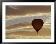 A Soaring Hot Air Balloon Against A Cloud-Filled Sky At Dawn by Jason Edwards Limited Edition Print