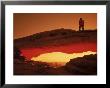 Hiker On Mesa Arch, Canyonlands National Park, Ut by Cheyenne Rouse Limited Edition Print