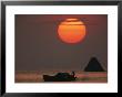 Kabang Silhouetted Against The Sea At Sunset by Nicolas Reynard Limited Edition Pricing Art Print